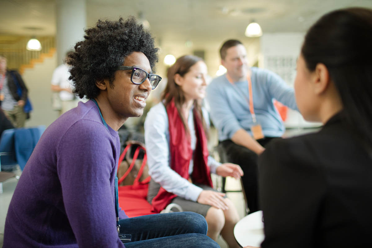 A diverse group of colleagues chatting in an informal meeting