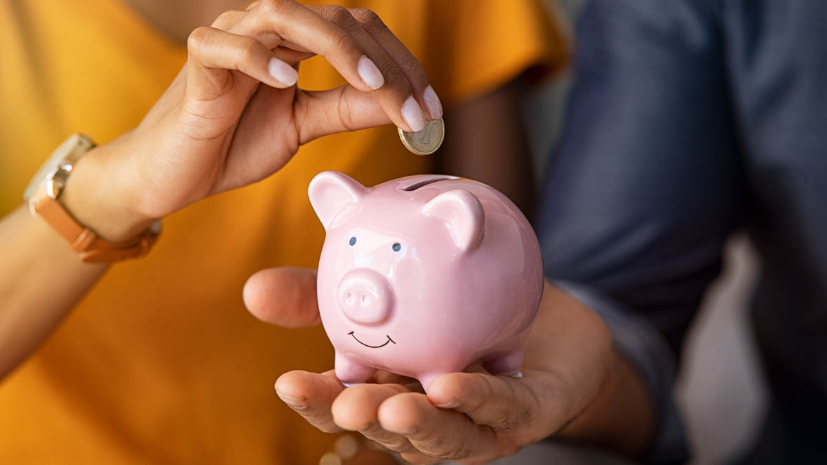 Couple saving money in piggybank